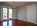 Dining room featuring French doors to the deck and sleek wood flooring at 3381 Birchwood Trl, Snellville, GA 30078