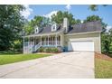 Inviting exterior of home featuring a covered porch and convenient two-car garage at 3381 Birchwood Trl, Snellville, GA 30078