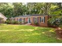 Well-maintained home with a lush green lawn, complemented by established landscaping at 1342 Old Johnson Ferry Ne Rd, Brookhaven, GA 30319