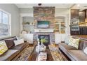 Living room featuring a stacked stone fireplace with custom built-ins and hardwood floors at 255 Southerland Ne Ter # 207, Atlanta, GA 30307