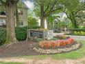 Stone sign for The Habersham of Buckhead, surrounded by lush, colorful landscaping and mature trees at 3655 Habersham Road Northeast Ne Rd # B249, Atlanta, GA 30305