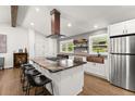Modern kitchen with a large island, stainless steel appliances, and copper accents at 6875 Sunny Brook Lane Northeast, Sandy Springs, GA 30328