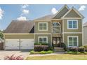 Two-story home with a three car garage, stone accents, and beautiful curb appeal at 875 Soaring Cir, Marietta, GA 30062