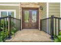 Elegant stone entryway with double front doors and wrought iron railing at 875 Soaring Cir, Marietta, GA 30062