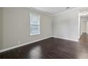 Bright bedroom with modern, dark floors and ample natural light at 1696 Thomas St, Decatur, GA 30032