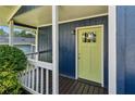 Inviting front porch features a vibrant yellow door and freshly painted railings at 1696 Thomas St, Decatur, GA 30032