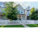 Inviting two-story home showcases a classic white picket fence and lush green trees at 3057 Windover Ln, Kennesaw, GA 30144