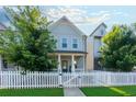 Charming two-story home features a classic white picket fence and lush green trees at 3057 Windover Ln, Kennesaw, GA 30144