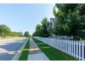 A row of townhomes with a white picket fence lining the sidewalk at 3057 Windover Ln, Kennesaw, GA 30144