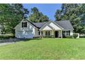Charming one-story home boasts a two-car garage and a well-manicured front lawn at 969 Bob Hannah Cir, Lawrenceville, GA 30044