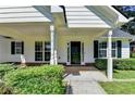 The home has a inviting covered front porch with classic columns and landscaping at 969 Bob Hannah Cir, Lawrenceville, GA 30044