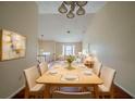 Inviting dining area with modern chandelier and hardwood floors, blending seamlessly into the bright and open living space at 1060 Heatherwood Ct, Norcross, GA 30093