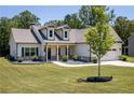 Inviting single-Gathering home with a well-manicured lawn and charming landscaping elements at 2124 Bullock Bluff Dr, Loganville, GA 30052