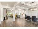 Open floor plan with coffered ceilings and hardwood floors seamlessly connects living room to kitchen at 2124 Bullock Bluff Dr, Loganville, GA 30052