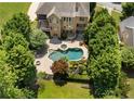 Aerial view of backyard featuring inground pool, hot tub, and mature landscaping at 307 Heritage Overlook, Woodstock, GA 30188