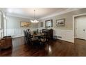 Formal dining room with hardwood floors, wainscoting and elegant chandelier at 1020 Matheson Way, Johns Creek, GA 30022