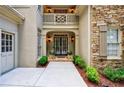 Welcoming front entrance with double doors, sconces, and manicured landscaping at 1020 Matheson Way, Johns Creek, GA 30022