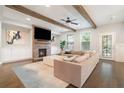 Comfortable living room with a fireplace, ceiling fan, exposed beams and a large sofa at 1878 Weston Ln, Tucker, GA 30084