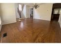 Elegant dining room featuring hardwood floors, chandelier, and wainscoting at 5014 Dovecote Trl, Suwanee, GA 30024