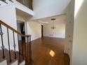 Open dining room boasts hardwood floors and modern chandelier at 5014 Dovecote Trl, Suwanee, GA 30024