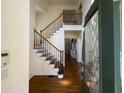 Welcoming home entryway featuring hardwood floors and a staircase with iron balusters at 5014 Dovecote Trl, Suwanee, GA 30024