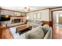 Comfortable living room with brick fireplace, wood mantel, and hardwood floors at 5018 Old Ivy Rd, Peachtree Corners, GA 30096