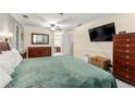 Spacious main bedroom featuring plush carpet, ceiling fan and ensuite bathroom access at 5018 Old Ivy Rd, Peachtree Corners, GA 30096