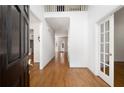 Bright foyer with hardwood floors and a view of the upper level balcony at 672 Red Sunset Cir, Powder Springs, GA 30127