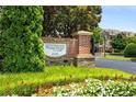 Westwood Park sign with colorful flowers and lush greenery at 11271 Calypso Dr, Alpharetta, GA 30009