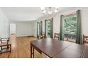Dining area featuring hardwood floors, a chandelier, and natural light from the adjacent windows at 1194 Robert Ln, Marietta, GA 30062