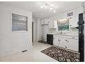 Functional kitchen featuring white cabinets, black appliances, and updated light fixtures at 1194 Robert Ln, Marietta, GA 30062