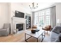 Cozy living room showcasing a stone fireplace, a large window, and elegant decor at 144 Northern Ave, Decatur, GA 30030