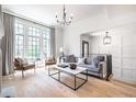 Bright living room featuring large windows, hardwood floors, and stylish contemporary furniture at 144 Northern Ave, Decatur, GA 30030