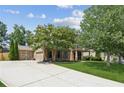 Attractive home with a long driveway leading to a two-car garage, complemented by lush greenery at 558 Grand Ivey Pl, Dacula, GA 30019