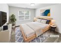 Virtually staged bedroom with large window, neutral tones, and modern decor at 2470 Arnold Mill Rd, Lawrenceville, GA 30044