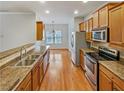 Well-lit kitchen featuring stainless steel appliances and wood cabinets at 2470 Arnold Mill Rd, Lawrenceville, GA 30044
