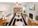 Staged living room with fireplace, hardwood floors, and built-in bookshelves at 2470 Arnold Mill Rd, Lawrenceville, GA 30044