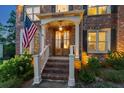Charming front entrance with brick steps, white railings, and a warm, inviting doorway at 7048 Bennington Ln, Cumming, GA 30041