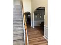 Open foyer features hardwood floors and a carpeted staircase with wood detailing at 1038 Island View Ct, Buford, GA 30518