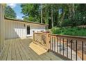 Wooden back deck with a railing, offering a view of the backyard and additional outdoor space at 5360 Fieldgreen Dr, Stone Mountain, GA 30088
