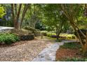 Stunning landscaping featuring stone walkway, rock garden, and mature trees at 410 Waterridge Ct, Sandy Springs, GA 30350