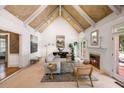 Bright living room featuring high ceilings, fireplace, and access to outdoor deck at 410 Waterridge Ct, Sandy Springs, GA 30350