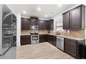 Well-equipped kitchen with stainless steel appliances and dark wood cabinetry at 4227 Meadow Wind Dr, Snellville, GA 30039
