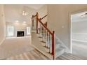 Cozy living room with a fireplace, large windows, and access to the stairway at 430 Tara Oaks Ct, Lawrenceville, GA 30043