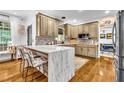Bright kitchen featuring an island with marble countertop and stainless steel appliances at 2455 Stonevalley Ln, Cumming, GA 30041