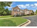 Well-manicured lawn and exterior view of townhomes, showcasing the neighborhood's curb appeal at 3028 Sw Deerborne Court Sw Ct, Atlanta, GA 30331