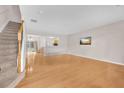 Bright living room featuring hardwood floors, stairs, and an open layout at 3028 Sw Deerborne Court Sw Ct, Atlanta, GA 30331