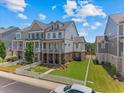 Charming townhome showcasing a manicured front yard, white picket fence and lovely brick and siding elevation at 630 Brashy St, Woodstock, GA 30188