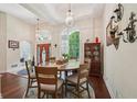 Bright dining area with high ceilings, wood floors, decorative lighting, and large windows at 105 Postwood Dr, Fayetteville, GA 30215
