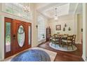Elegant foyer with wood floors, light fixtures, and an arched window for natural light at 105 Postwood Dr, Fayetteville, GA 30215